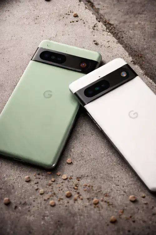 Close-up vertical photo of Google Pixel phones placed flat, highlighting camera bar and minimalist back design.