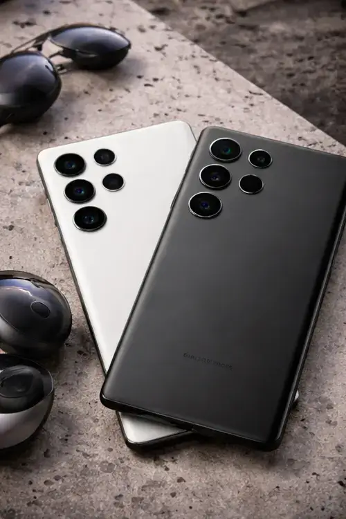 Vertical image of Samsung Galaxy phones placed on a surface, emphasizing advanced camera lenses and premium matte finish